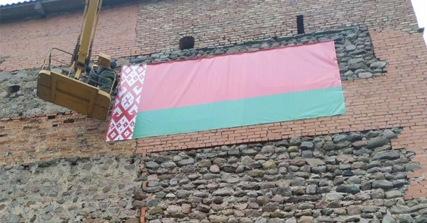 На стену Лидского замка повесили государственный флаг, а вечером — сняли